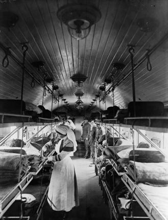 Interior of a ward on a British ambulance train showing the narrow aisle and triple bunks.  Courtesy Imperial War Museum © IWM (Q 8749)